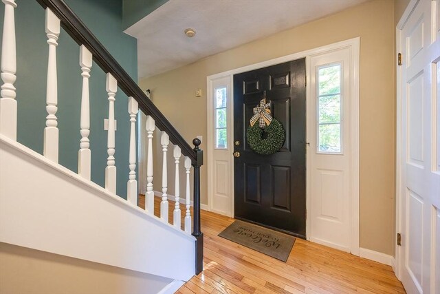 495 Creek St, Wrentham, MA 02093 - entryway with healthy amount of natural light, hardwood / wood-style flooring, stairway, and baseboards