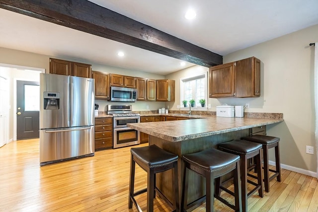495 Creek St, Wrentham, MA 02093 - kitchen featuring stainless steel appliances, beamed ceiling, a sink, a peninsula, and light wood finished floors