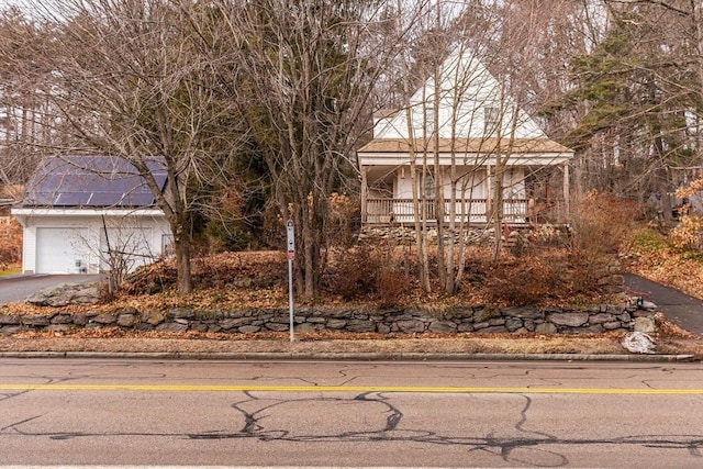 view of front facade with solar panels and a porch