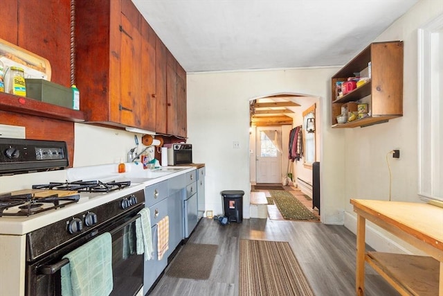 kitchen with range with gas stovetop, arched walkways, dark wood-style floors, open shelves, and light countertops