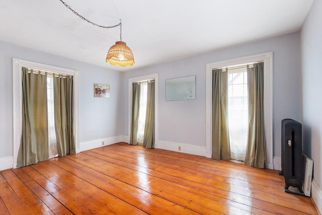 empty room with light wood-style flooring and baseboards