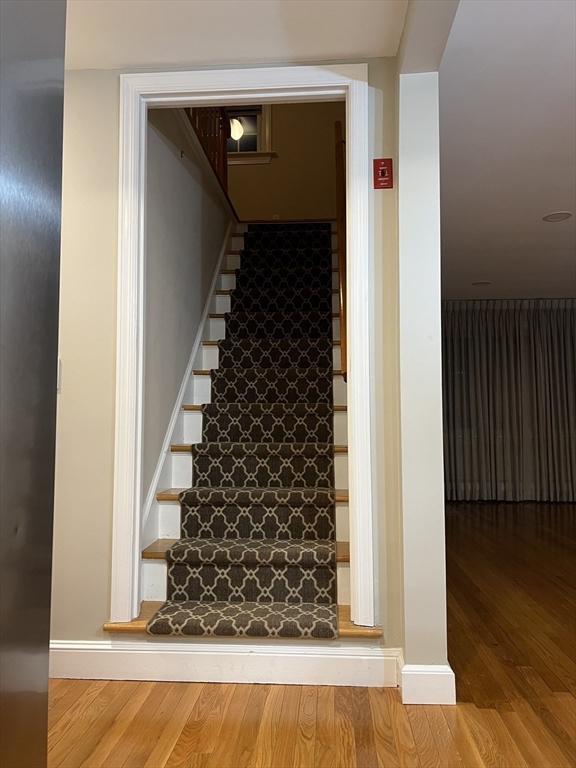 stairway featuring hardwood / wood-style floors