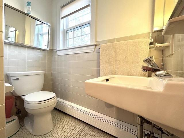 bathroom featuring tile walls, tile patterned floors, and toilet