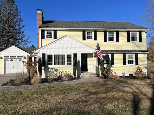 view of front of property featuring a garage and a front yard