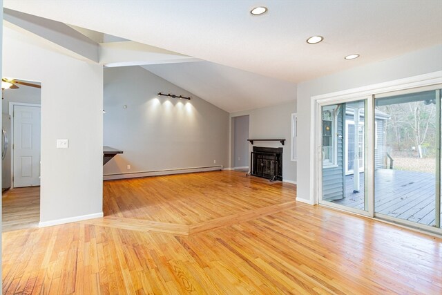 unfurnished living room featuring ceiling fan, light hardwood / wood-style floors, lofted ceiling, and a baseboard heating unit