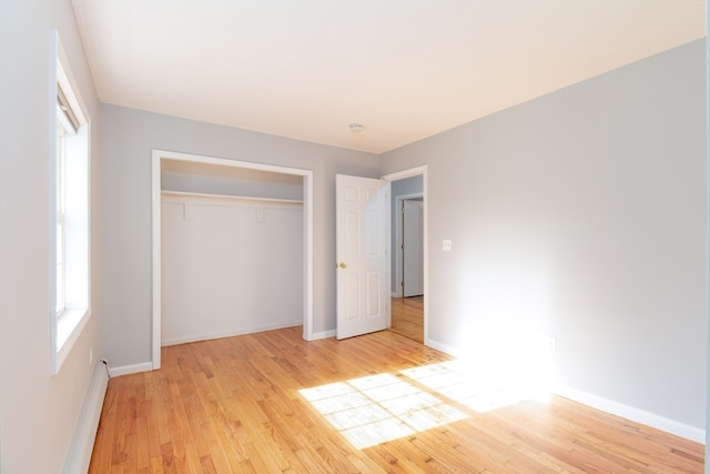 unfurnished bedroom featuring a closet and light hardwood / wood-style flooring