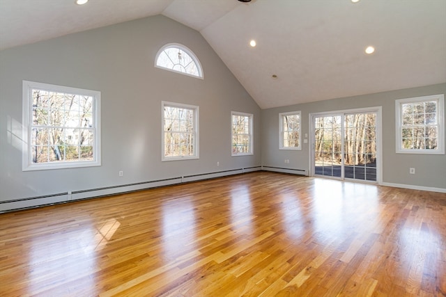 unfurnished living room with light hardwood / wood-style floors, baseboard heating, and high vaulted ceiling