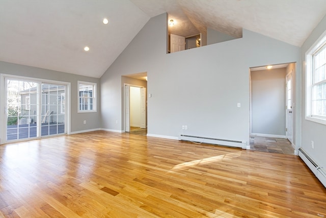 unfurnished living room with light wood-type flooring, high vaulted ceiling, and a baseboard radiator