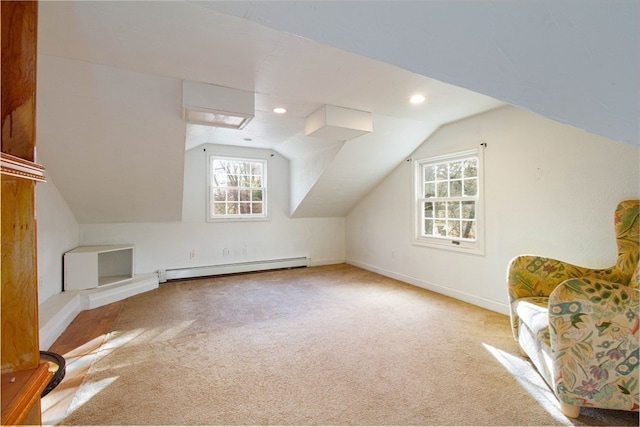 additional living space with carpet floors, a baseboard radiator, and vaulted ceiling