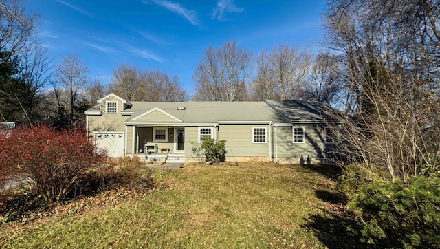 back of house with a yard, a porch, and a garage