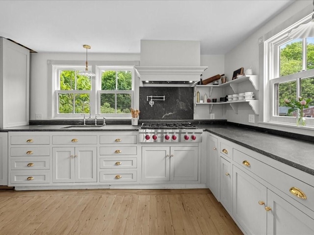 131 Cedar St, Middleboro, MA 02346 - kitchen with stainless steel gas cooktop, a sink, dark countertops, open shelves, and tasteful backsplash