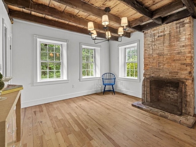 131 Cedar St, Middleboro, MA 02346 - unfurnished living room featuring wooden ceiling with exposed beams, healthy amount of natural light, light wood-style flooring, baseboards, and a chandelier