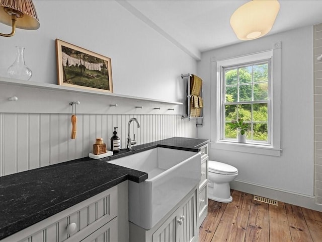 131 Cedar St, Middleboro, MA 02346 - bathroom with wood-type flooring, toilet, and baseboards