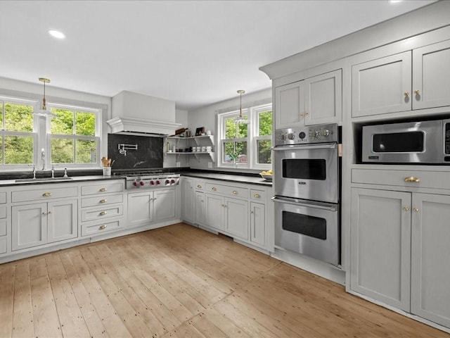 131 Cedar St, Middleboro, MA 02346 - kitchen with stainless steel appliances, a sink, dark countertops, light wood-style flooring, and recessed lighting