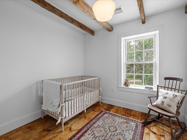 131 Cedar St, Middleboro, MA 02346 - bedroom featuring beamed ceiling, wood-type flooring, and baseboards