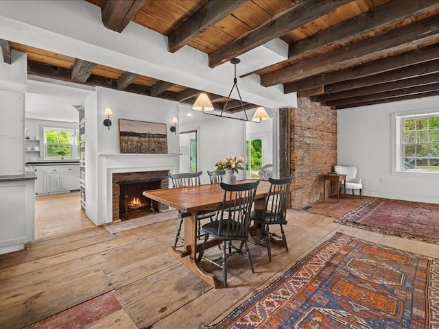 131 Cedar St, Middleboro, MA 02346 - dining space featuring light wood-style flooring, a lit fireplace, plenty of natural light, and wood ceiling with exposed beams
