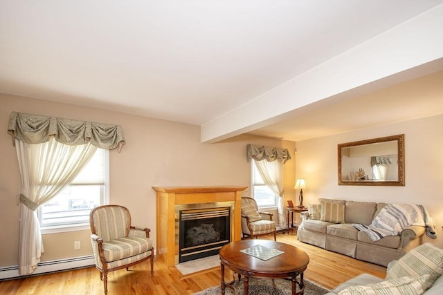 25 11th Rd, Marshfield, MA 02050 - living room with a baseboard heating unit, a fireplace with flush hearth, and light wood finished floors
