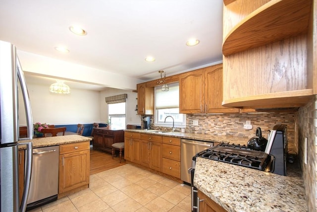 25 11th Rd, Marshfield, MA 02050 - kitchen featuring stainless steel appliances, a sink, light tile patterned floors, backsplash, and light stone counters