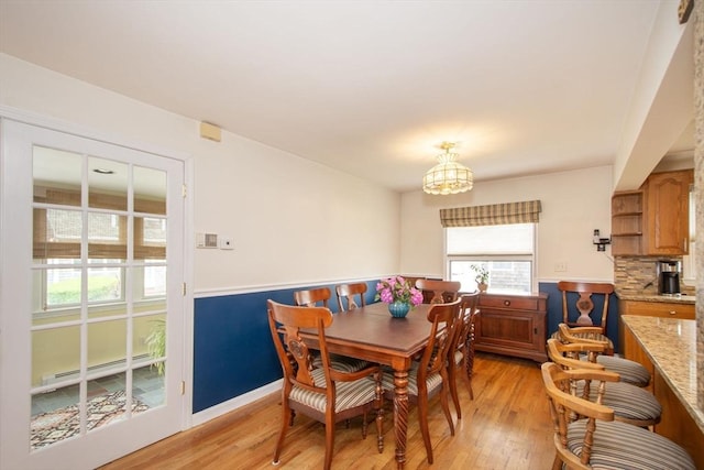 25 11th Rd, Marshfield, MA 02050 - dining space featuring a baseboard heating unit, light wood-style flooring, and a chandelier