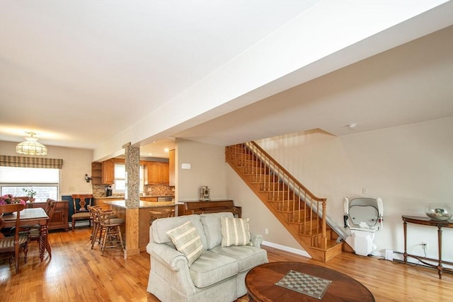 25 11th Rd, Marshfield, MA 02050 - living area featuring a baseboard radiator, stairway, light wood-style floors, and a chandelier