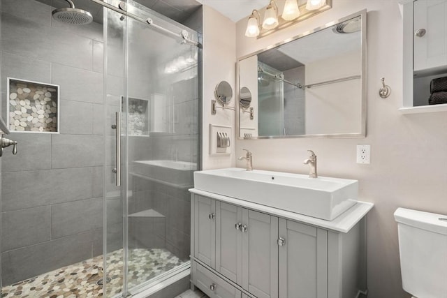 full bath with a shower stall, toilet, and vanity