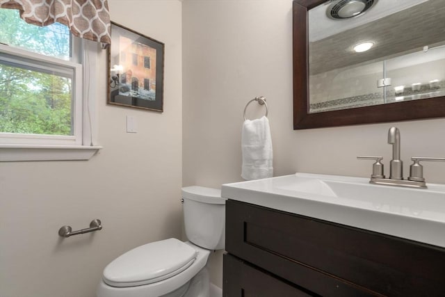 bathroom featuring toilet and vanity