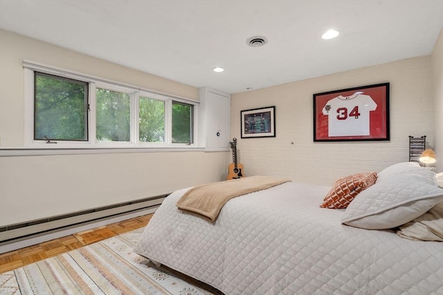 bedroom with recessed lighting, baseboard heating, and brick wall
