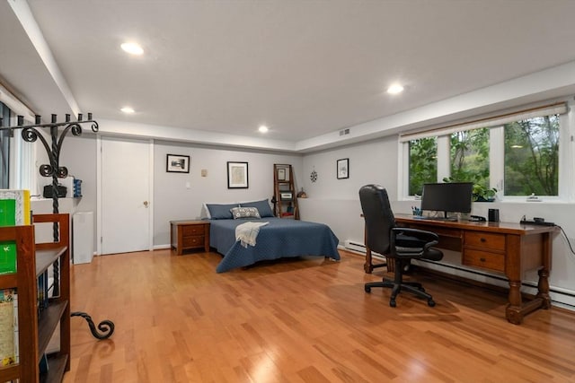 bedroom with light wood finished floors, recessed lighting, and a desk
