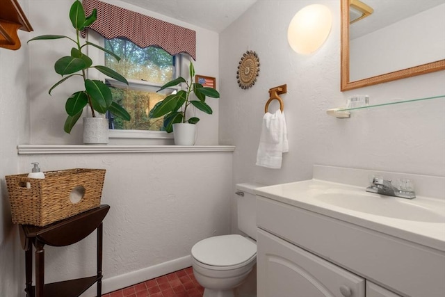 half bath featuring toilet, vanity, and baseboards