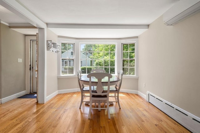 38 Fairmount Rd, Reading, MA 01867 - dining space featuring a baseboard radiator, a wall mounted air conditioner, and light wood-type flooring