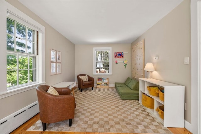 38 Fairmount Rd, Reading, MA 01867 - living area with a baseboard radiator, plenty of natural light, and light floors