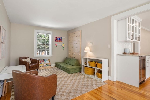 38 Fairmount Rd, Reading, MA 01867 - living area featuring light wood finished floors, beverage cooler, and bar