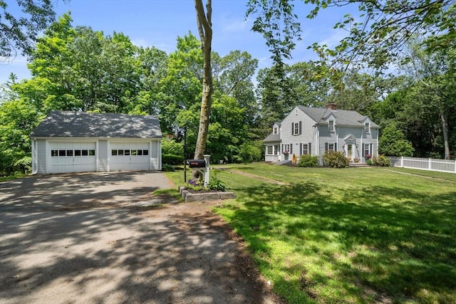 38 Fairmount Rd, Reading, MA 01867 - view of front of home with an outbuilding, a detached garage, view of scattered trees, and a chimney