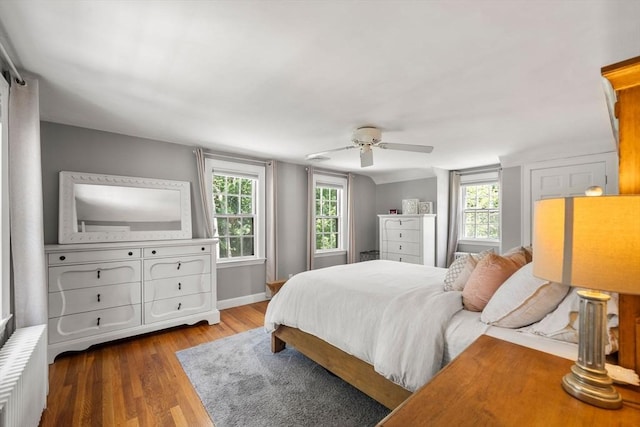 38 Fairmount Rd, Reading, MA 01867 - bedroom featuring radiator heating unit, wood finished floors, multiple windows, and a ceiling fan
