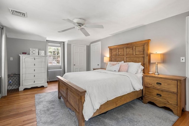 38 Fairmount Rd, Reading, MA 01867 - bedroom with radiator, light wood-style flooring, and ceiling fan