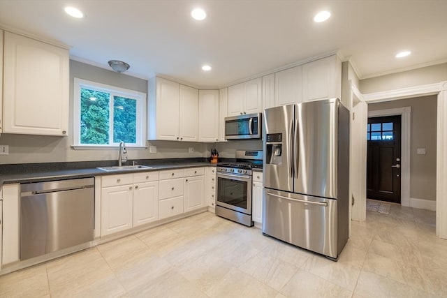 57 Clapp St, Walpole, MA 02081 - kitchen with stainless steel appliances, a sink, dark countertops, white cabinetry, and recessed lighting