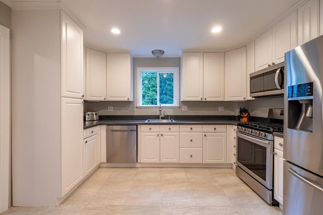 57 Clapp St, Walpole, MA 02081 - kitchen with appliances with stainless steel finishes, a sink, dark countertops, white cabinets, and recessed lighting