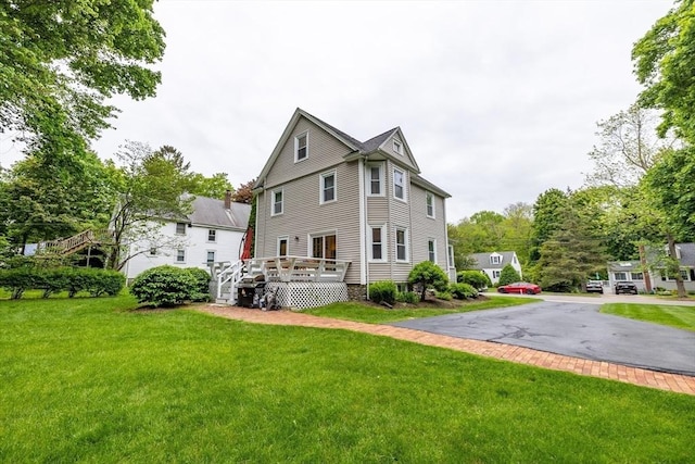 57 Clapp St, Walpole, MA 02081 - back of house with a deck and a lawn