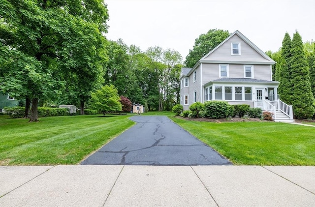 57 Clapp St, Walpole, MA 02081 - view of front of house with driveway and a front lawn