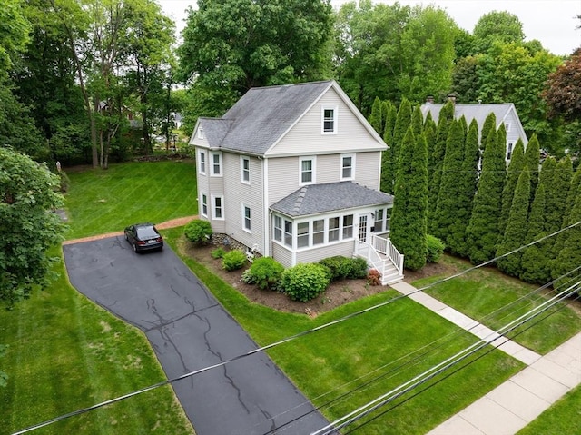 57 Clapp St, Walpole, MA 02081 - view of front of property featuring driveway, roof with shingles, a front lawn, and view of wooded area