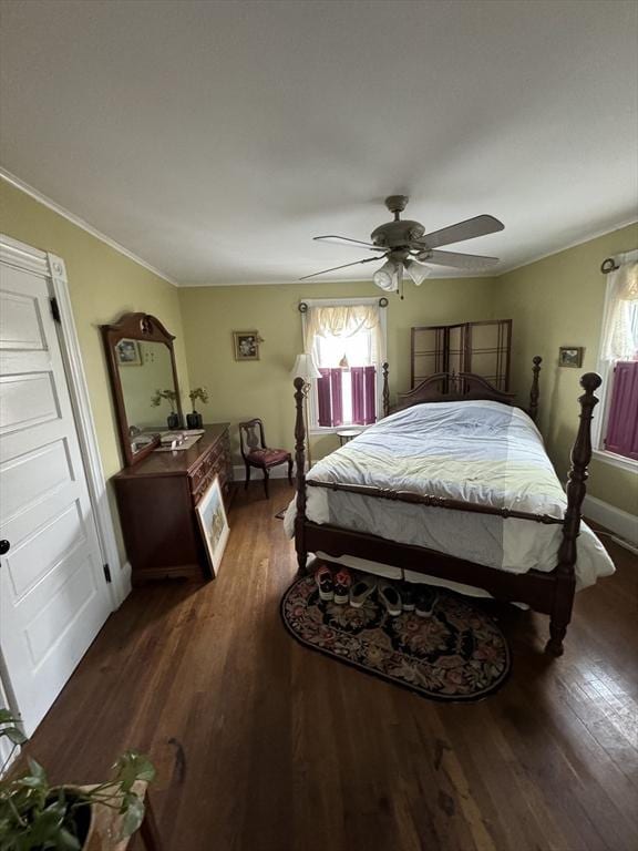 bedroom featuring ornamental molding, ceiling fan, baseboards, and wood finished floors