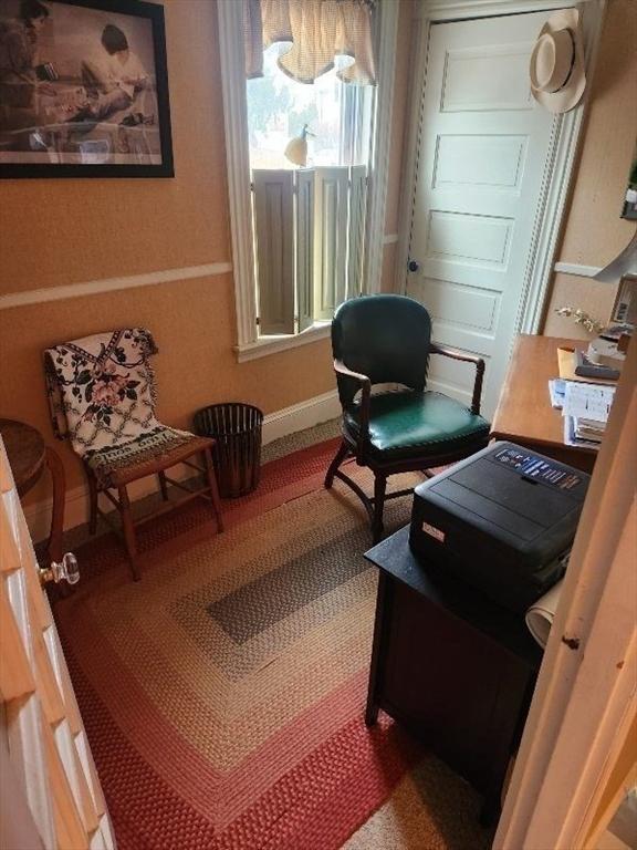 living area featuring baseboards