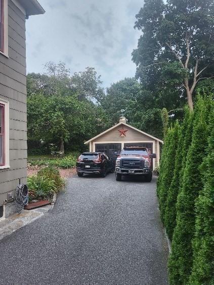 view of parking / parking lot with a detached garage