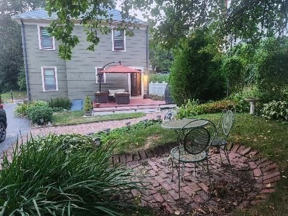 rear view of property featuring a patio area