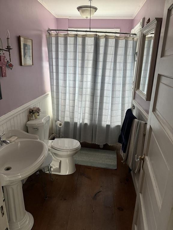 full bath with a wainscoted wall, crown molding, toilet, and hardwood / wood-style flooring