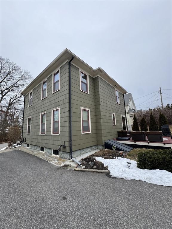 view of property exterior with a wooden deck