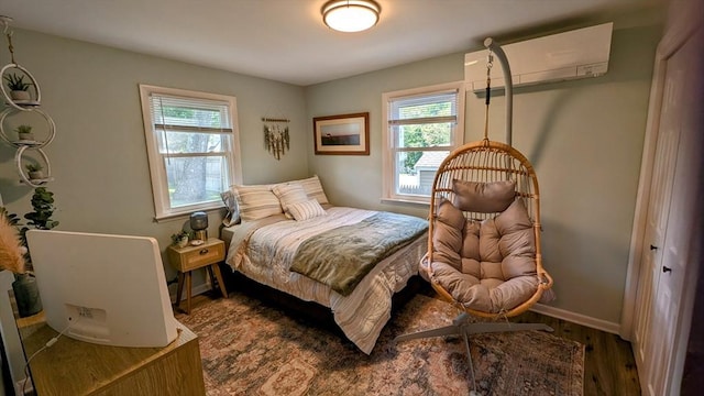 3 Bennett St, Hudson, MA 01749 - bedroom featuring multiple windows, an AC wall unit, wood finished floors, and baseboards