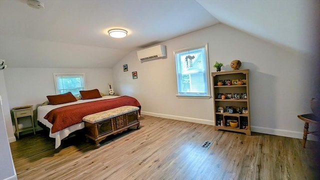 3 Bennett St, Hudson, MA 01749 - bedroom featuring lofted ceiling, wood finished floors, a wall unit AC, and baseboards