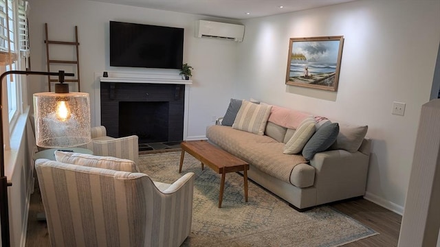 3 Bennett St, Hudson, MA 01749 - living area featuring a wall mounted air conditioner, wood finished floors, baseboards, a fireplace, and recessed lighting