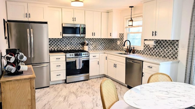 3 Bennett St, Hudson, MA 01749 - kitchen featuring stainless steel appliances, a sink, light countertops, and decorative backsplash